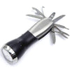 10 Function Flashlight Survival Tool Distinctive Mad Man flash light with several hidden tools in the handle. Great for the man on the go. Includes, scissors, saw blade, knife. Tools include , scissors, saw blade, knife. Stainless steel with matte black contrast There ideal men's accessory for home and car Material: Stainless Steel | Plastic Dimensions: 6" x 2.5"